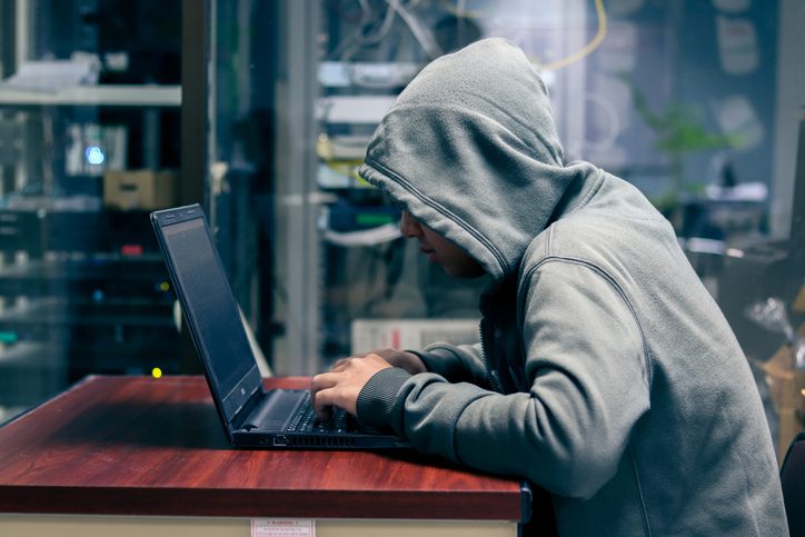 Hacker is Using Computer for Organizing Massive Data Breach Attack on Corporate Servers. Their Hideout is Dark